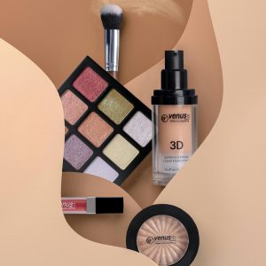 Flat lay of cosmetics including eyeshadow, lipstick, and blush with neutral tones.